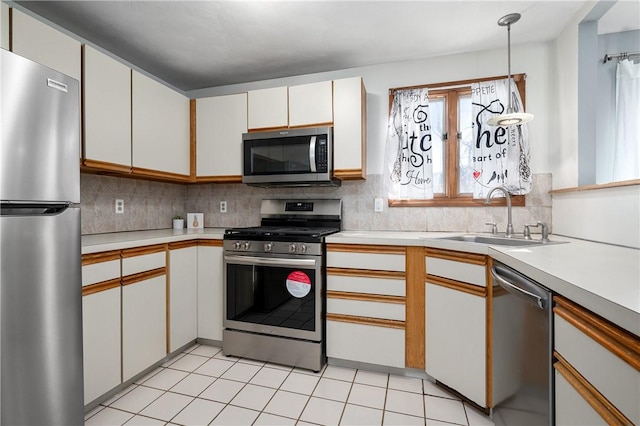 kitchen featuring white cabinetry, stainless steel appliances, sink, and decorative backsplash