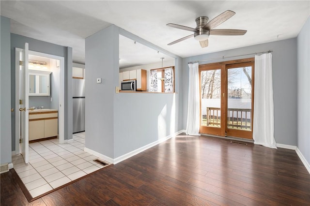 unfurnished room with ceiling fan and light hardwood / wood-style flooring