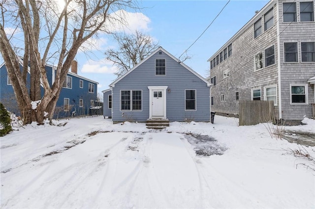 view of snow covered back of property