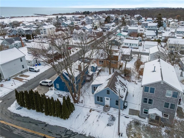 snowy aerial view featuring a water view