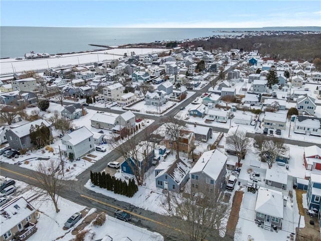 snowy aerial view featuring a water view