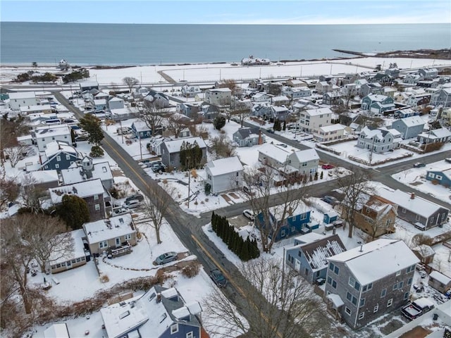 snowy aerial view featuring a water view