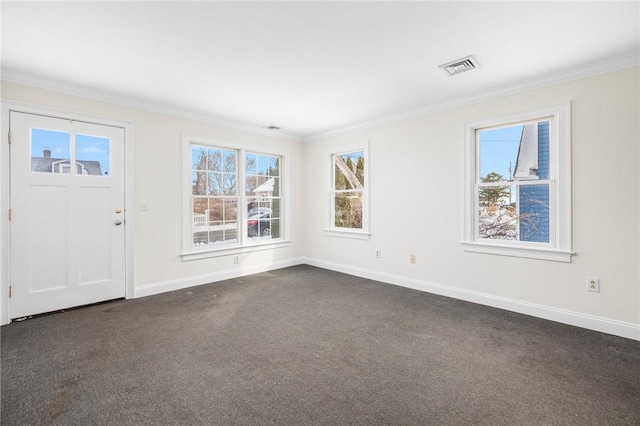 carpeted foyer with crown molding