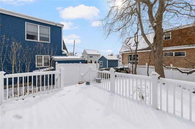 snowy yard with a deck