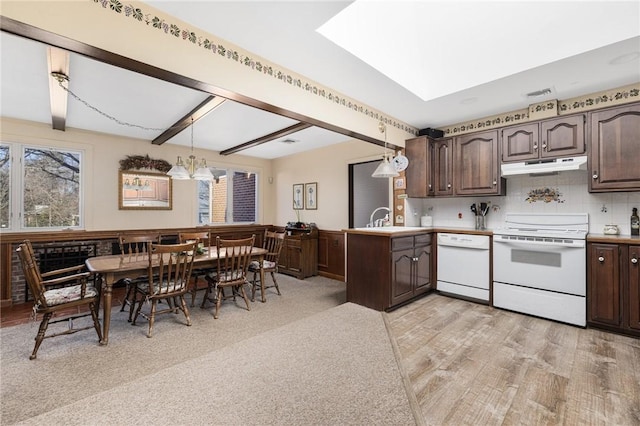 kitchen with tasteful backsplash, white appliances, dark brown cabinets, and hanging light fixtures