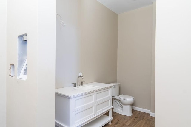 bathroom featuring vanity, toilet, and wood-type flooring