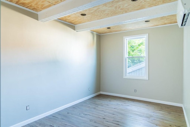 unfurnished room with hardwood / wood-style flooring, a wall mounted air conditioner, wooden ceiling, and beamed ceiling