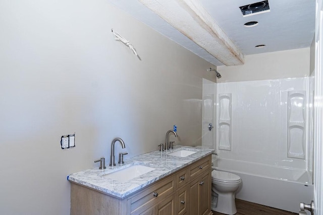 full bathroom with hardwood / wood-style flooring, vanity, shower / bathtub combination, and toilet