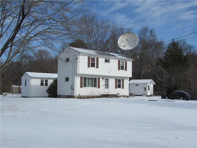 view of front of property featuring a shed