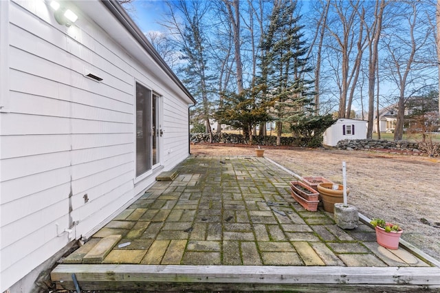 view of patio featuring a storage unit