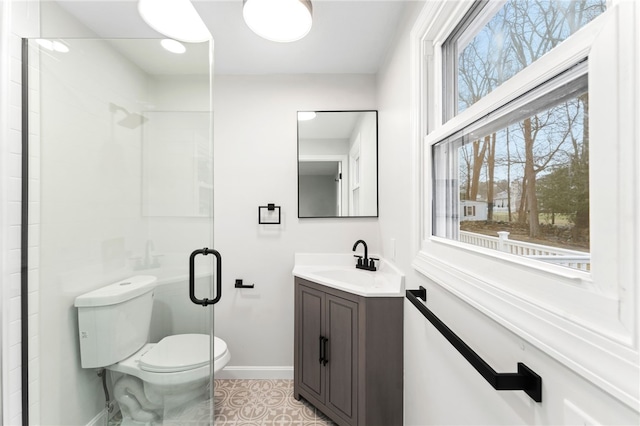 bathroom with vanity, tile patterned flooring, toilet, and walk in shower