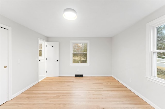 empty room with light hardwood / wood-style floors