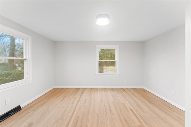 spare room featuring light wood-type flooring