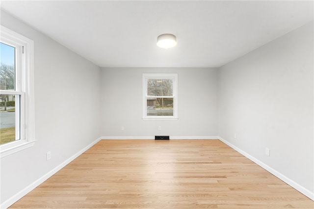 unfurnished room with plenty of natural light and light wood-type flooring