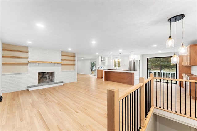 living room featuring a fireplace and light wood-type flooring