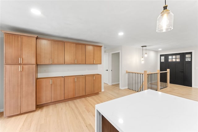 kitchen featuring hanging light fixtures and light hardwood / wood-style flooring