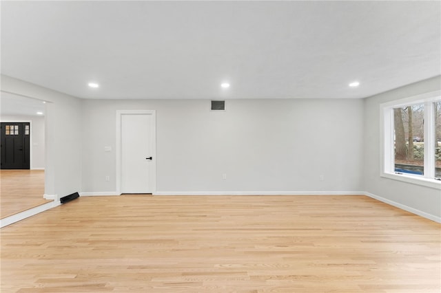 unfurnished room with light hardwood / wood-style flooring