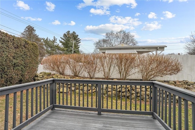 wooden terrace featuring a yard