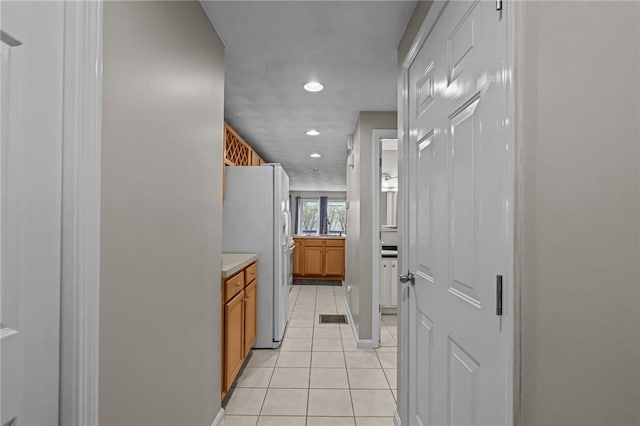 hallway with light tile patterned floors