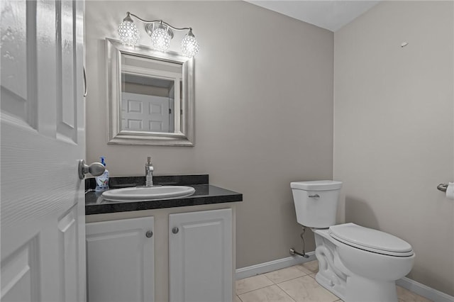 bathroom with vanity, toilet, and tile patterned flooring