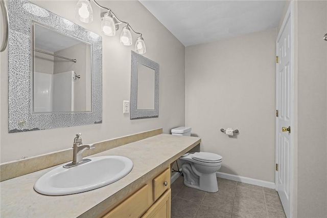 bathroom with vanity, tile patterned flooring, toilet, and a shower