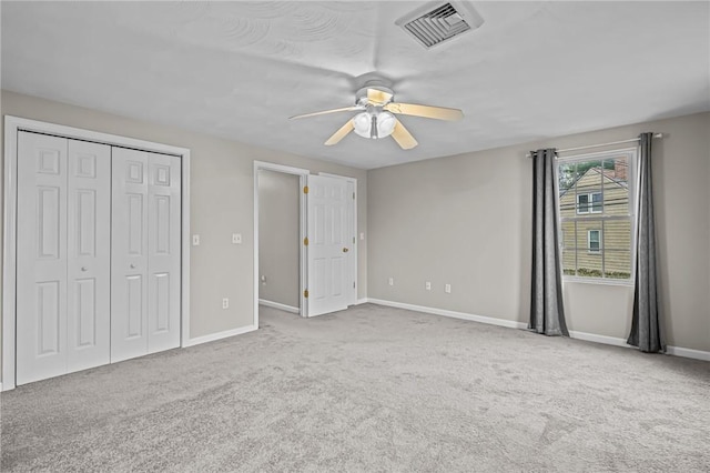 unfurnished bedroom with a closet, ceiling fan, and carpet flooring