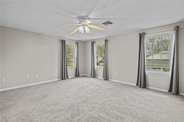 unfurnished room featuring ceiling fan and light carpet