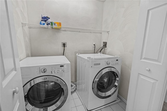 laundry area featuring light tile patterned flooring and separate washer and dryer