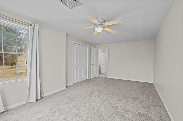 unfurnished bedroom with ceiling fan, a closet, and light carpet