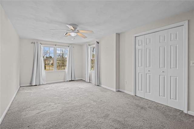 unfurnished bedroom featuring light carpet, a closet, and ceiling fan