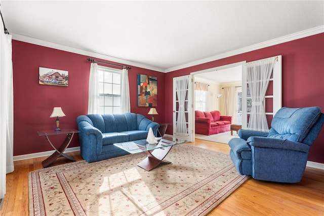 living room with crown molding, hardwood / wood-style floors, and french doors