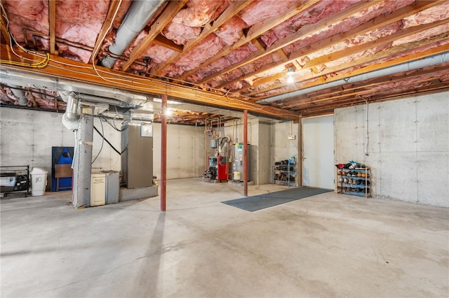 basement with water heater and heating unit