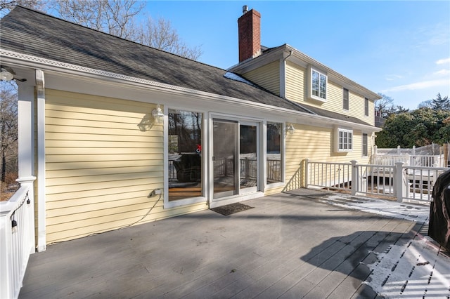 back of property featuring a wooden deck