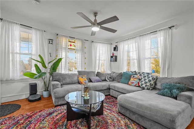 living room featuring wood-type flooring and ceiling fan