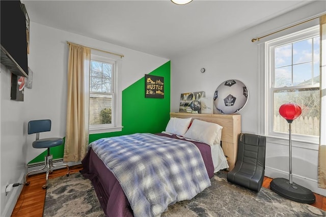 bedroom with dark wood-type flooring