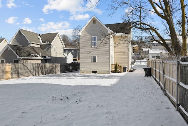 view of snow covered rear of property