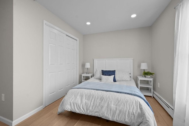 bedroom featuring light hardwood / wood-style flooring and a baseboard radiator