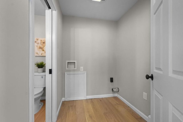 laundry area with light hardwood / wood-style flooring