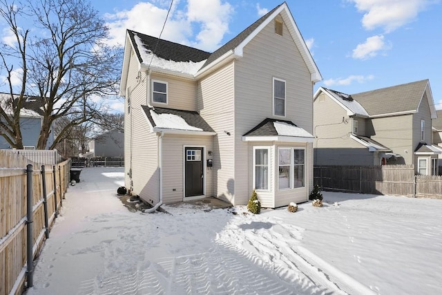 view of snow covered rear of property