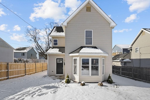 view of snow covered rear of property