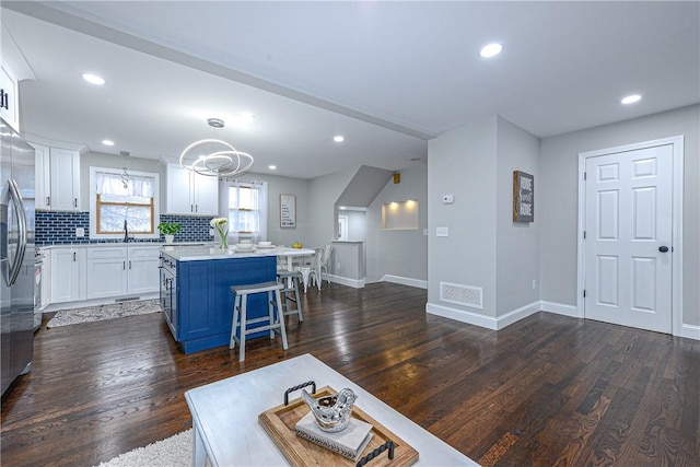 living room featuring dark hardwood / wood-style flooring and sink