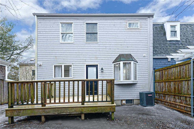 rear view of property featuring a wooden deck and central air condition unit