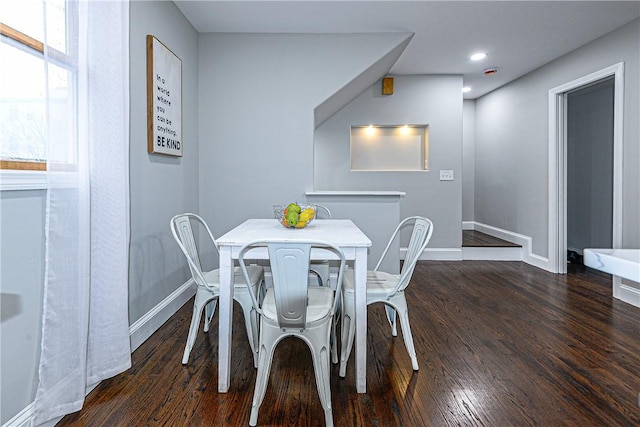 dining space featuring dark wood-type flooring