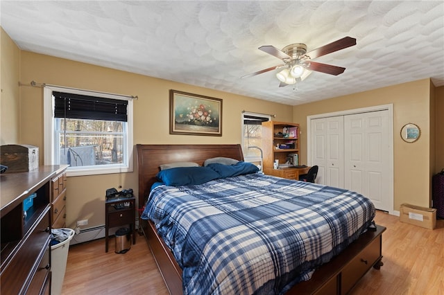 bedroom with a closet, multiple windows, and light wood-type flooring