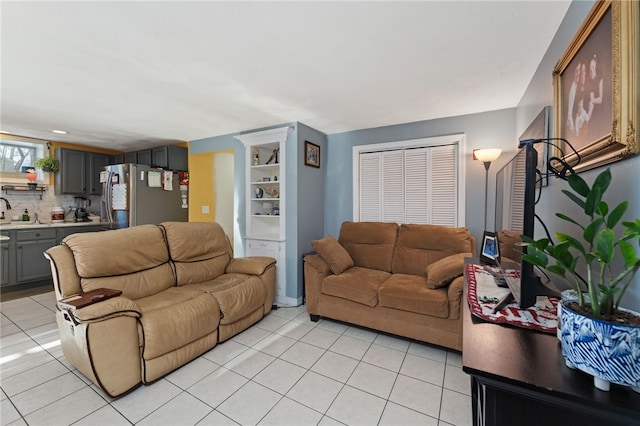 living room featuring light tile patterned flooring and sink