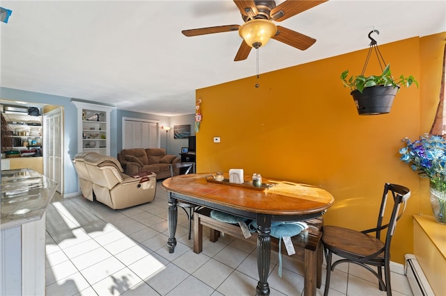 dining room featuring ceiling fan, light tile patterned floors, and baseboard heating