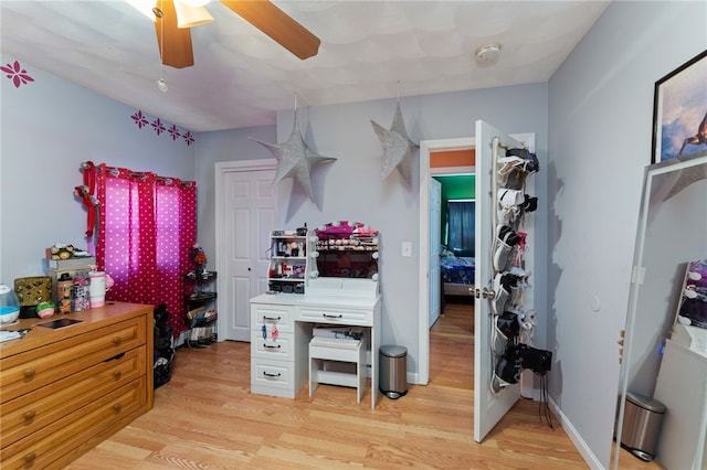 kitchen with ceiling fan, white cabinets, and light wood-type flooring