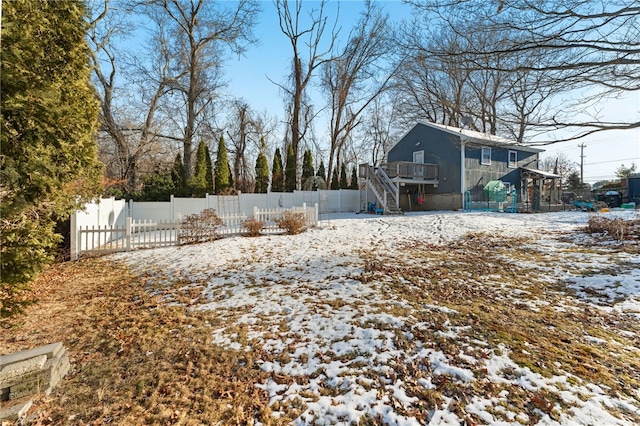 yard covered in snow with a wooden deck