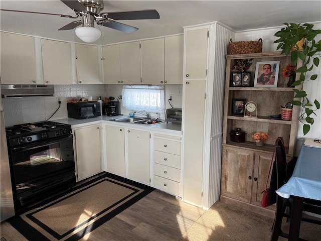 kitchen featuring backsplash, white cabinets, sink, and black appliances