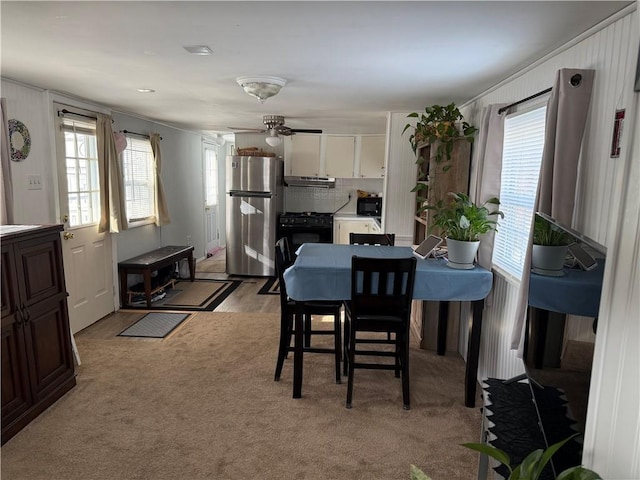 dining space featuring light colored carpet